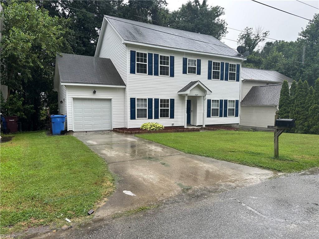 5029 John St, Chesapeake, VA 23321 - colonial inspired home featuring an attached garage, concrete driveway, a front lawn, and roof with shingles