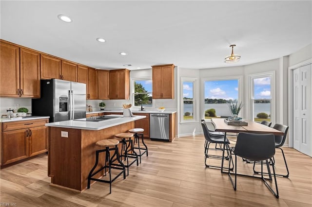 1545 Lake James Dr, Virginia Beach, VA 23464 - kitchen with appliances with stainless steel finishes, a kitchen breakfast bar, light countertops, recessed lighting, and light wood finished floors