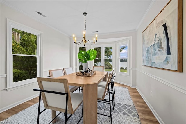 1545 Lake James Dr, Virginia Beach, VA 23464 - dining room with a chandelier, wood finished floors, ornamental molding, and a water view