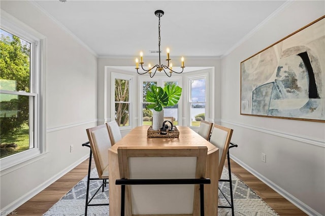1545 Lake James Dr, Virginia Beach, VA 23464 - dining area featuring healthy amount of natural light, a chandelier, dark wood finished floors, and crown molding