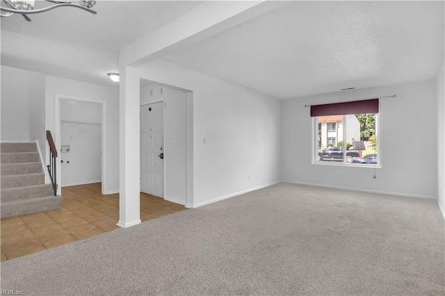 3555 Campion Ave, Virginia Beach, VA 23462 - carpeted empty room featuring stairway, tile patterned floors, and a textured ceiling