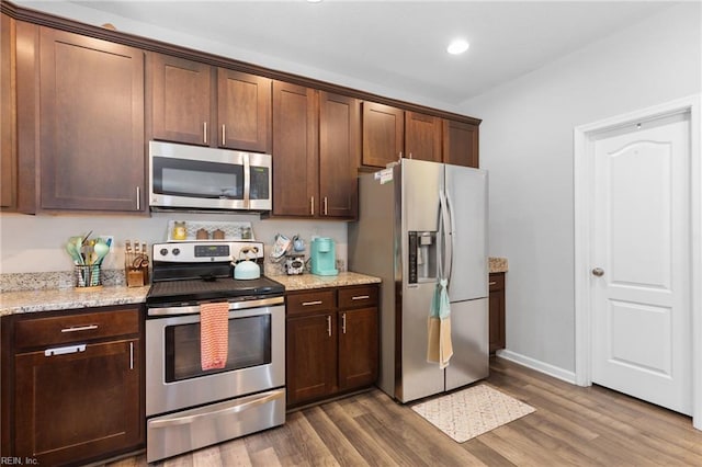 4202 Ravine Gap Dr, Suffolk, VA 23434 - kitchen featuring stainless steel appliances, dark wood-type flooring, light stone counters, recessed lighting, and dark brown cabinetry