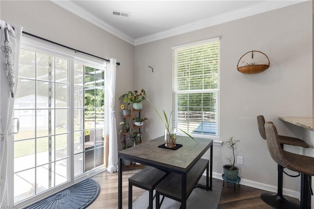 4202 Ravine Gap Dr, Suffolk, VA 23434 - dining space featuring wood finished floors and crown molding