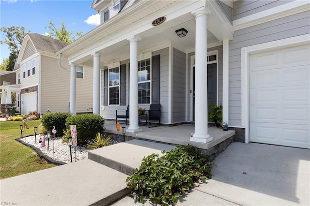4202 Ravine Gap Dr, Suffolk, VA 23434 - doorway to property featuring covered porch, a garage, and a yard