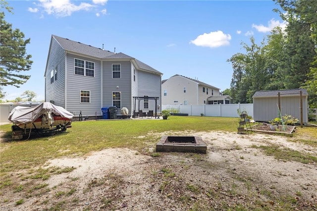 4202 Ravine Gap Dr, Suffolk, VA 23434 - rear view of house with a vegetable garden and an outdoor structure