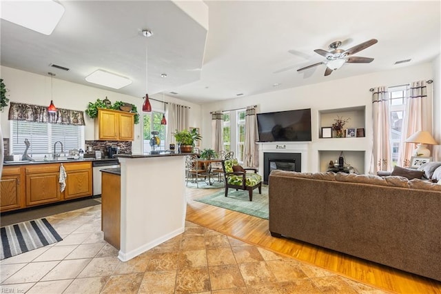 1513 Pebblebrook Way, Virginia Beach, VA 23464 - kitchen featuring dishwasher, dark countertops, a fireplace, open floor plan, and a ceiling fan