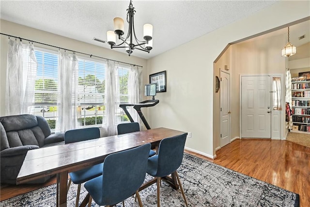 315 Sawmill Arch, Chesapeake, VA 23323 - dining space featuring a chandelier, a textured ceiling, and wood finished floors