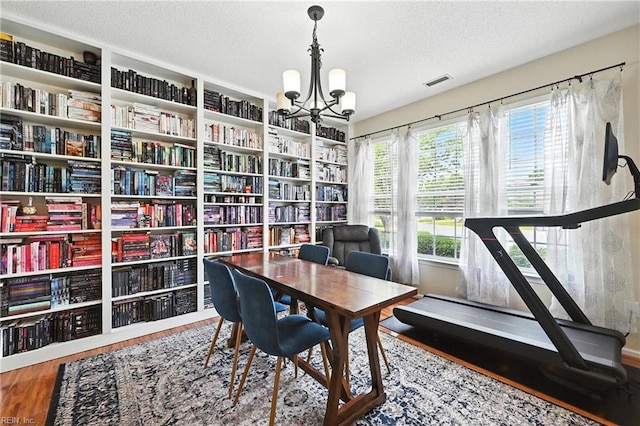315 Sawmill Arch, Chesapeake, VA 23323 - office featuring a textured ceiling, wood finished floors, wall of books, and a chandelier