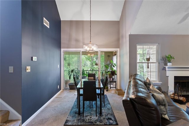 313 River Forest Rd, Virginia Beach, VA 23454 - carpeted dining room with high vaulted ceiling, a chandelier, and a glass covered fireplace