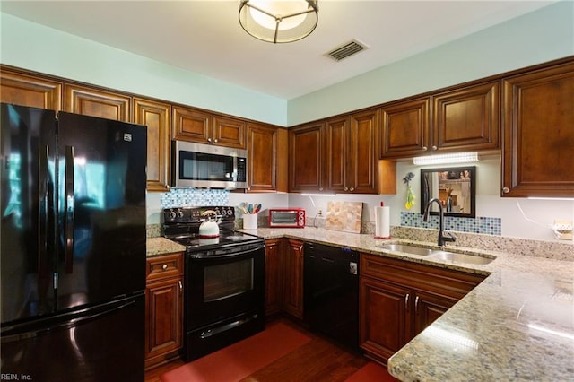 313 River Forest Rd, Virginia Beach, VA 23454 - kitchen featuring black appliances, light stone countertops, dark wood-style floors, and backsplash