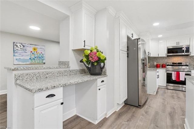 5016 Madeira Rd, Virginia Beach, VA 23455 - kitchen featuring appliances with stainless steel finishes, white cabinetry, light wood finished floors, and recessed lighting