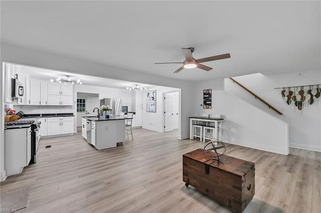 4057 Woodland Dr, Chesapeake, VA 23321 - living area with a chandelier, a ceiling fan, light wood-type flooring, and stairway