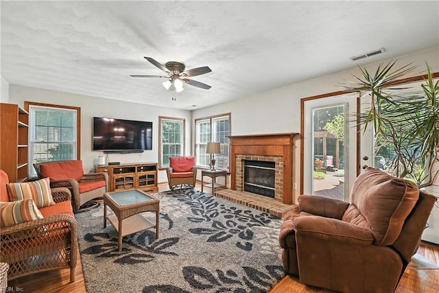 4300 Galston Ct, Chesapeake, VA 23321 - living room featuring ceiling fan, wood finished floors, healthy amount of natural light, and a fireplace