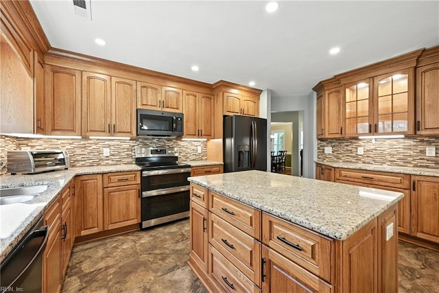 4300 Galston Ct, Chesapeake, VA 23321 - kitchen featuring black appliances, glass insert cabinets, tasteful backsplash, a center island, and light stone countertops