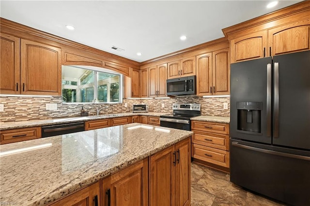 4300 Galston Ct, Chesapeake, VA 23321 - kitchen with black appliances, light stone countertops, tasteful backsplash, brown cabinetry, and recessed lighting