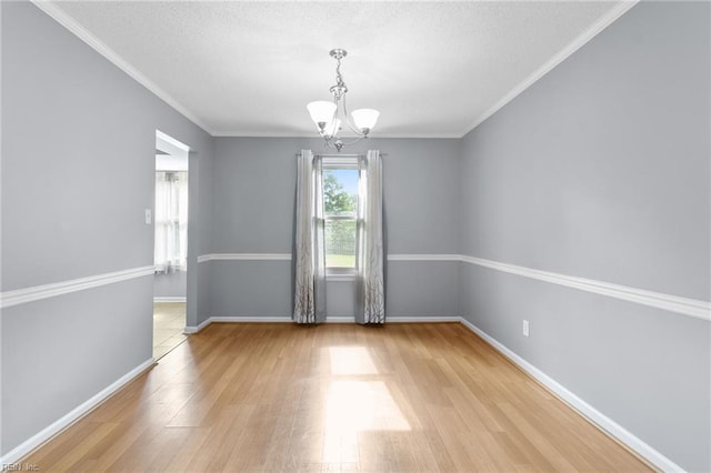 1760 Moonstone Dr, Virginia Beach, VA 23456 - spare room featuring a chandelier, wood finished floors, a textured ceiling, and crown molding