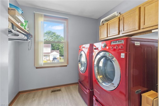 1760 Moonstone Dr, Virginia Beach, VA 23456 - laundry area featuring cabinet space, light wood-style floors, and washing machine and clothes dryer