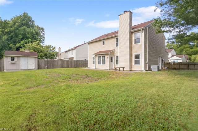 1760 Moonstone Dr, Virginia Beach, VA 23456 - back of house with a fenced backyard, a chimney, and a storage unit