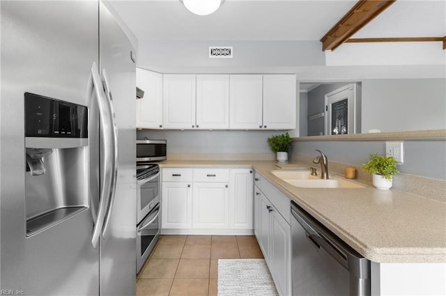 1760 Moonstone Dr, Virginia Beach, VA 23456 - kitchen with appliances with stainless steel finishes, light tile patterned floors, and white cabinets