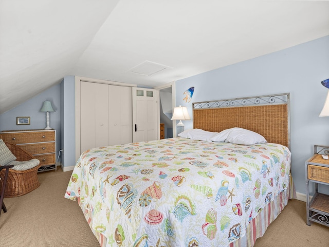 bedroom with light colored carpet, vaulted ceiling, and a closet