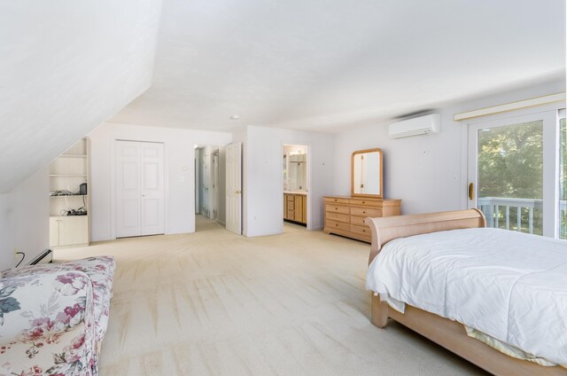 53 Snead Dr, Mashpee, MA 02649 - carpeted bedroom with access to outside, an AC wall unit, connected bathroom, a closet, and lofted ceiling