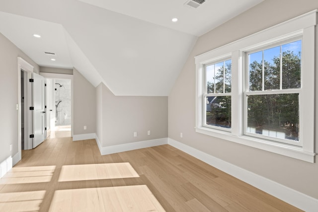 bonus room featuring light hardwood / wood-style flooring and lofted ceiling