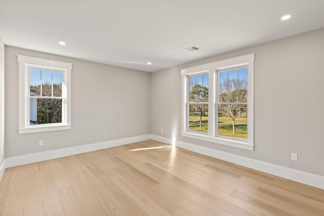 unfurnished room with light wood-type flooring