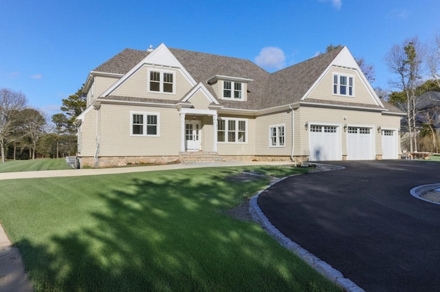 view of front of house with a garage and a front lawn