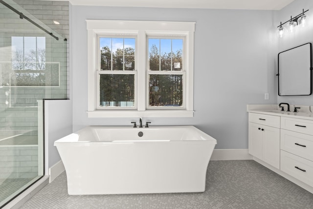 bathroom featuring shower with separate bathtub, tile patterned floors, and vanity