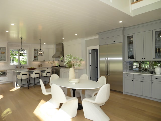18 Pleasant Park Dr, Mashpee, MA 02649 - dining space featuring light wood-type flooring, recessed lighting, and crown molding