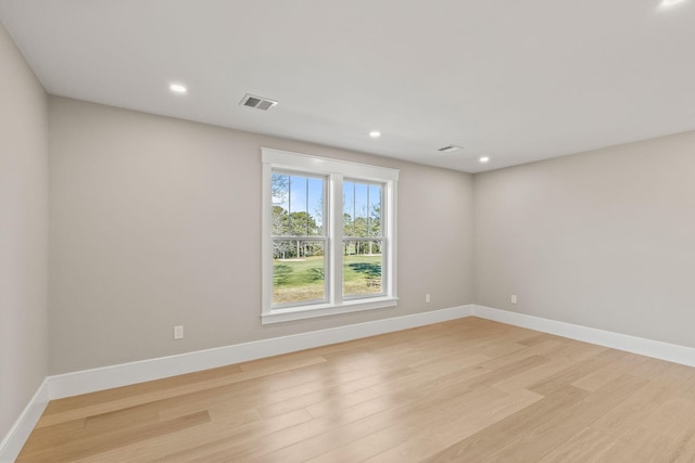 spare room with light hardwood / wood-style flooring