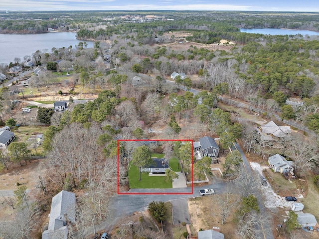 aerial view of property and surrounding area featuring a nearby body of water and property boundaries highlighted