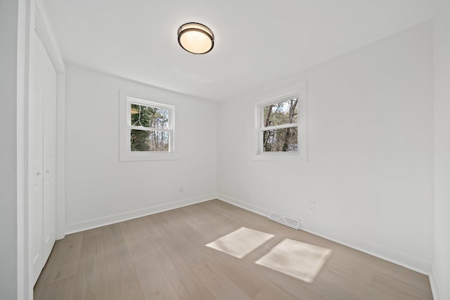 unfurnished bedroom with wood finished floors and baseboards