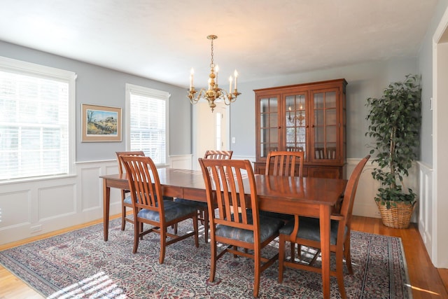 dining space featuring plenty of natural light, hardwood / wood-style floors, and a chandelier