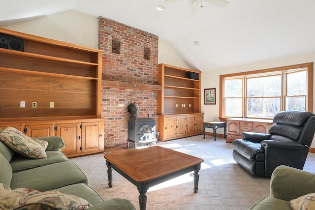 living room with a wood stove, ceiling fan, light carpet, and lofted ceiling