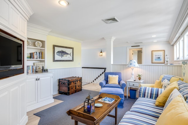 88 Champlain Rd, Chatham, MA 02633 - living room featuring wainscoting, crown molding, built in shelves, ornate columns, and recessed lighting