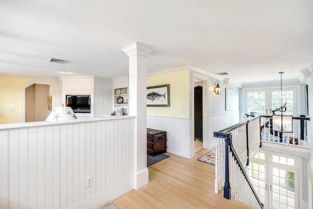 88 Champlain Rd, Chatham, MA 02633 - hall with an upstairs landing, light wood-style flooring, a wainscoted wall, and ornamental molding