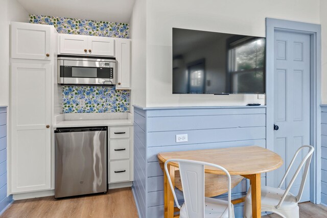 72 Forest Beach Rd, South Chatham, MA 02659 - kitchen with stainless steel appliances, light wood finished floors, white cabinets, and light countertops