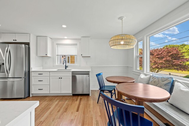 72 Forest Beach Rd, South Chatham, MA 02659 - kitchen featuring stainless steel appliances, a sink, light countertops, healthy amount of natural light, and wainscoting