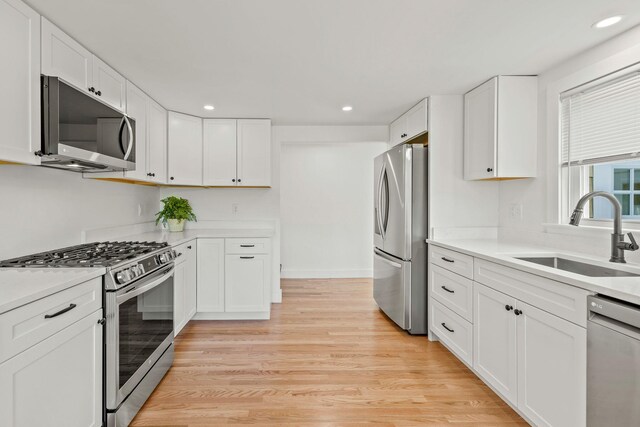 72 Forest Beach Rd, South Chatham, MA 02659 - kitchen featuring stainless steel appliances, a sink, recessed lighting, white cabinetry, and light wood-style flooring