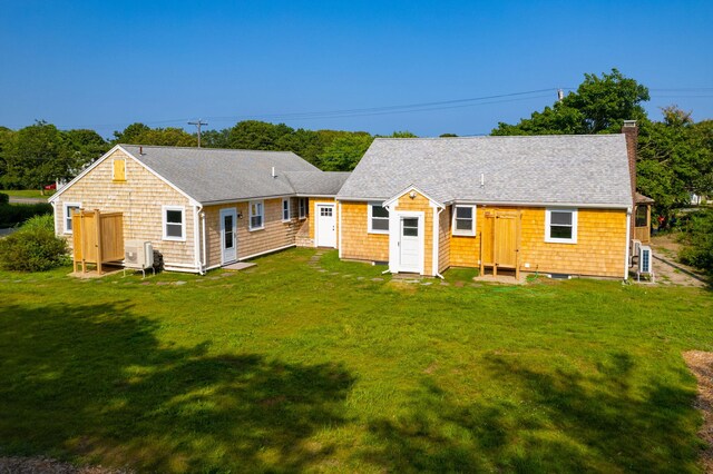 72 Forest Beach Rd, South Chatham, MA 02659 - rear view of property with a yard, a chimney, roof with shingles, and a cooling unit