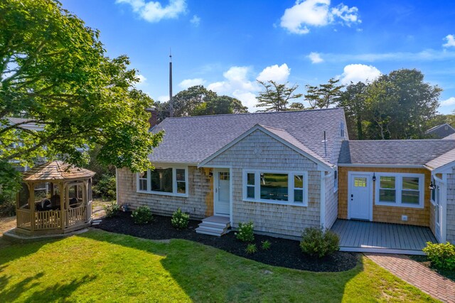 72 Forest Beach Rd, South Chatham, MA 02659 - view of front of house featuring a gazebo, a shingled roof, a front lawn, a chimney, and a deck