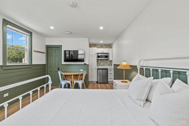 72 Forest Beach Rd, South Chatham, MA 02659 - bedroom featuring wood finished floors, a wainscoted wall, and fridge