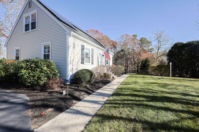 view of property exterior with a yard