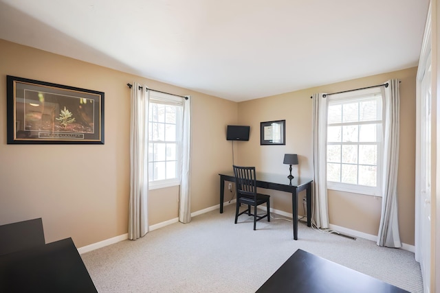 carpeted office space with a healthy amount of sunlight