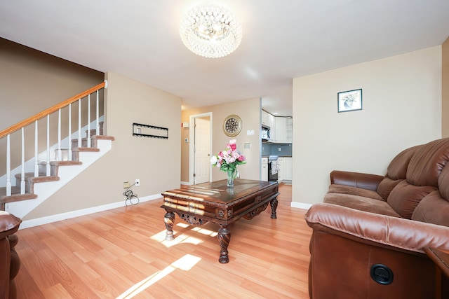 living room featuring a notable chandelier and wood-type flooring