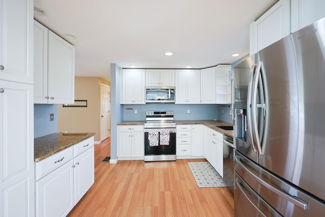 kitchen with white cabinetry and appliances with stainless steel finishes