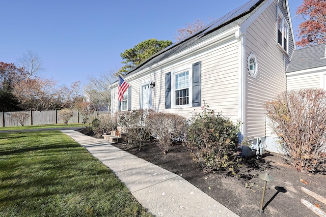 view of side of home featuring a yard