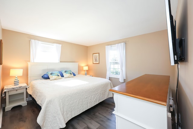 bedroom with dark wood-type flooring