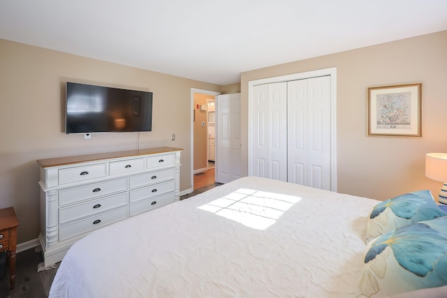 bedroom featuring a closet and dark hardwood / wood-style flooring